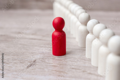 red leader businessman with crowd of wooden men. leadership, business, team, teamwork and Human resource management concept