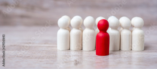 red leader businessman with crowd of wooden men. leadership, business, team, teamwork and Human resource management concept