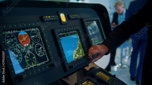 A man controls the flight of an airplane - a world map on the screen photo