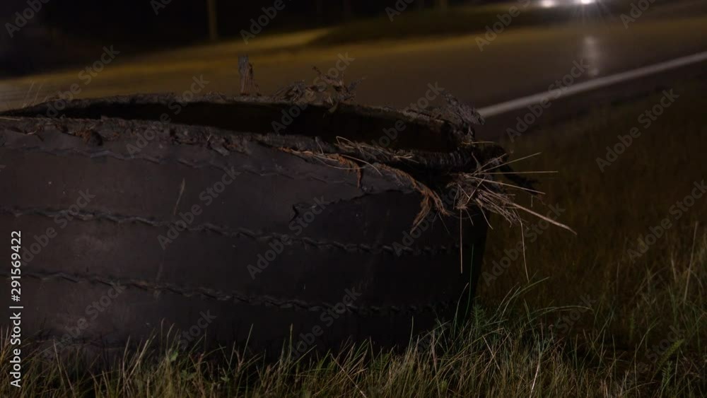 Exploded tire of semi truck on highway roadside at night. Stock ビデオ ...