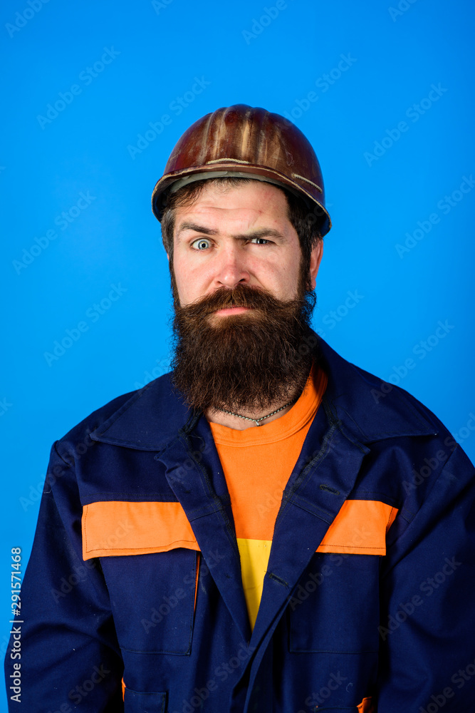 Fototapeta premium Mechanical worker. Bearded man in suit with construction helmet. Portrait of handsome engineer. Construction worker in hardhat. Business, industry, technology - builder concept. Builder in hard hat.