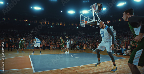 Basketball players on big professional arena during the game. Tense moment of the game. Celebration