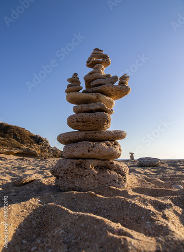Stack of stones in balance on the beach of Trafalgar Lighthouse. C  diz  Andalusia. Spain