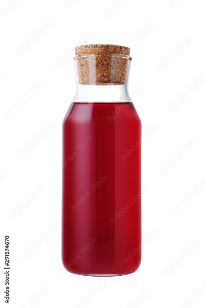 Red glass bottle of juice or compote on a white isolated background. Homemade lemonade carafe on a white background. Red glass bottle of juice or compote on a white isolated background. Homemade lemonade carafe on a white background.