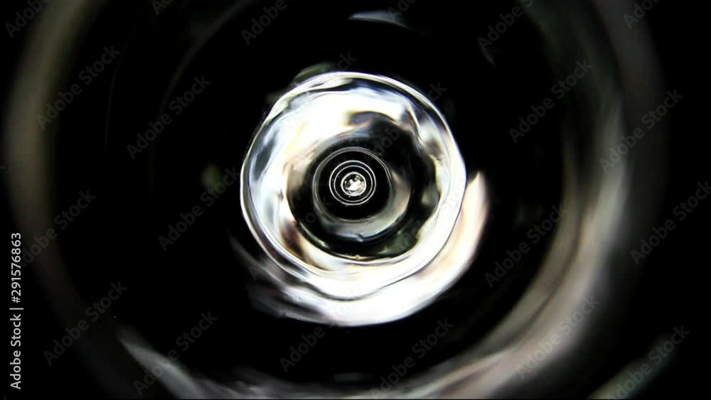 hypnotizing pulsating light source in glass cylinder on black background hypnotizing pulsating light source in glass cylinder on black background