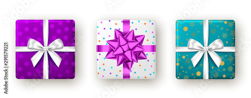 Gift box with purple, white ribbon and bow, top view.