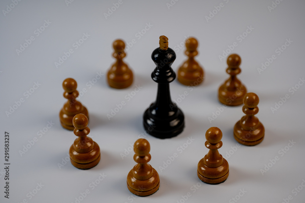 Chess pieces, black king surrounded by white pawns Chess pieces, black king surrounded by white pawns
