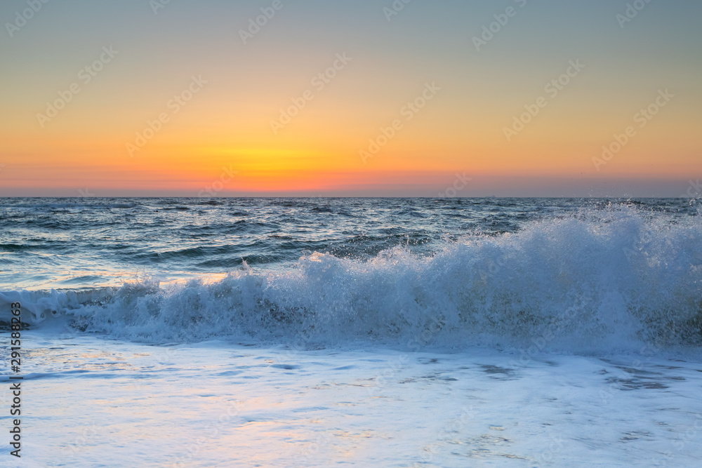 Sea and waves in the morning nice sunrise colors background