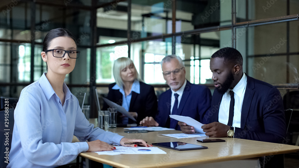 Experienced female employee in eyeglasses looking camera, consulting service Experienced female employee in eyeglasses looking camera, consulting service