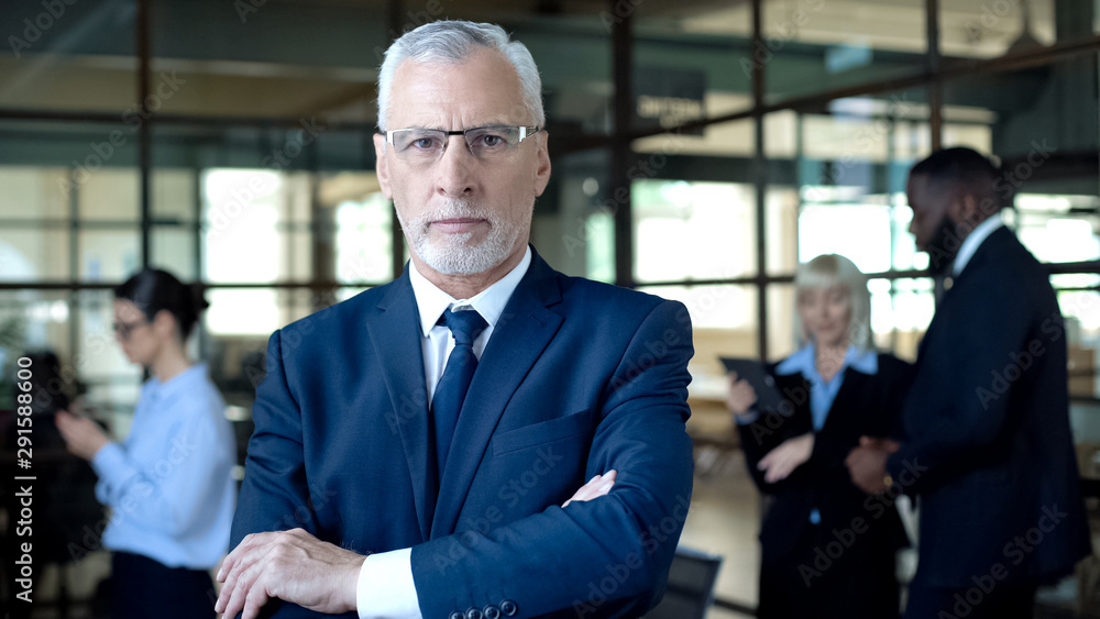 Self-confident aged man in suit looking camera, business leader, company career Self-confident aged man in suit looking camera, business leader, company career