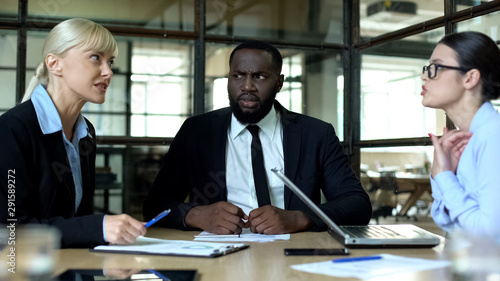 Photography Black businessman tired of female conflicts in office, business ethic concept