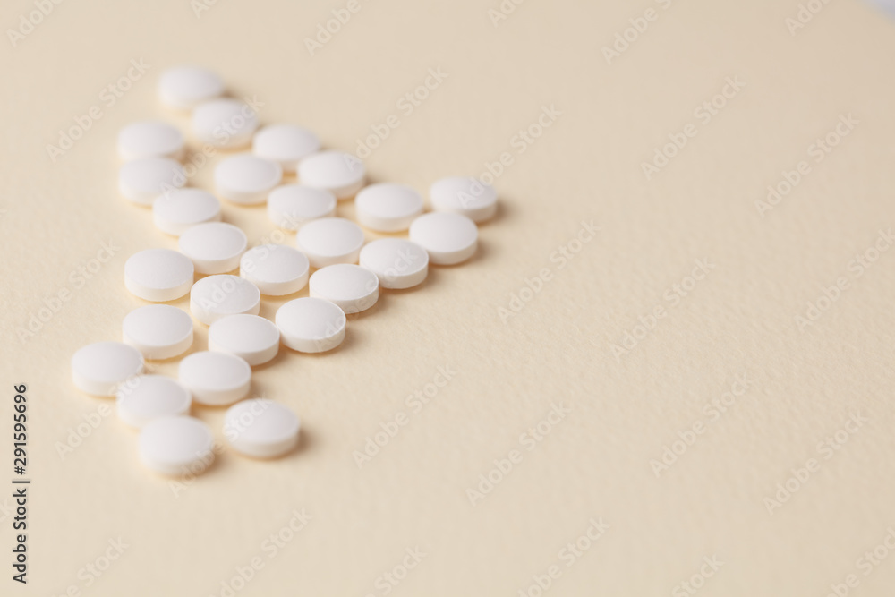 Biotin Tablets. Bright paper background. Close up. Copy space. 