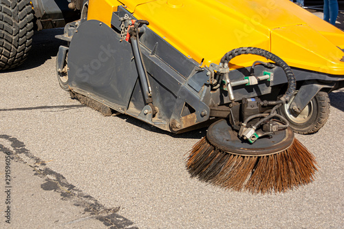 Industrial sweeper, road cleaner with brushes. Brushing the road. The concept of community road services, street cleaning. road equipment.