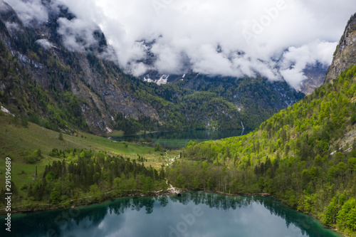 Scenic mountain panorama with green meadows and idyllic turquoise Lake Oberer