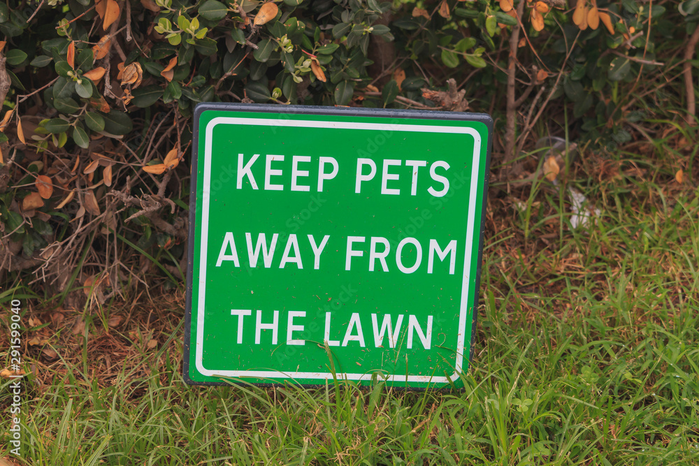 Green infrmation sign KEEP PETS AWAY FROM THE LAWN
