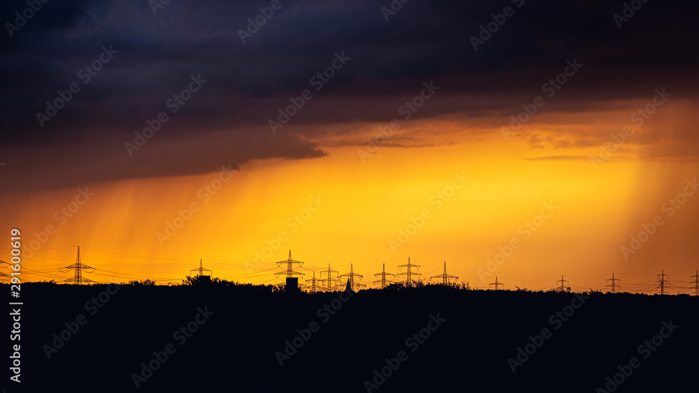 Storm clouds over the poles with a power line