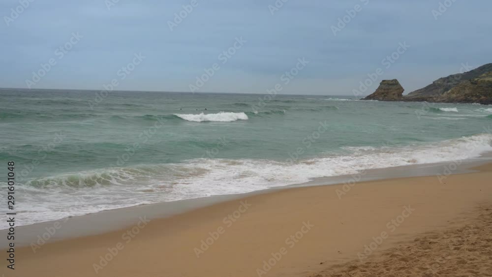 people surf the ocean. cloudy day in autumn people surf the ocean. cloudy day in autumn
