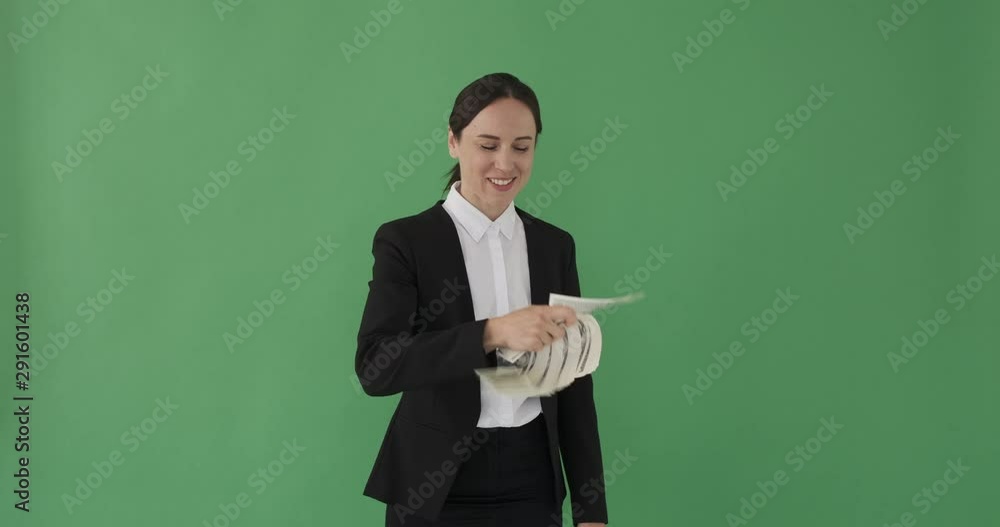 Pleased businesswoman waving and smelling hundred dollar notes over green background Pleased businesswoman waving and smelling hundred dollar notes over green background