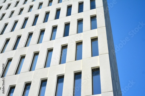 Modern office building detail. Perspective view of geometric angular concrete windows on the facade of a modernist brutalist style building. 
