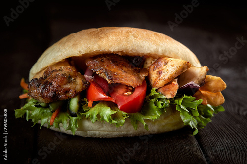 close up of kebab sandwich on wooden background