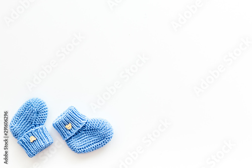 Cute baby booties for boy on white background top view copyspace