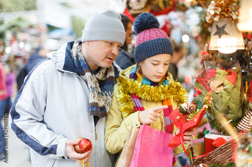 Girl with father choosing Xmas decoration