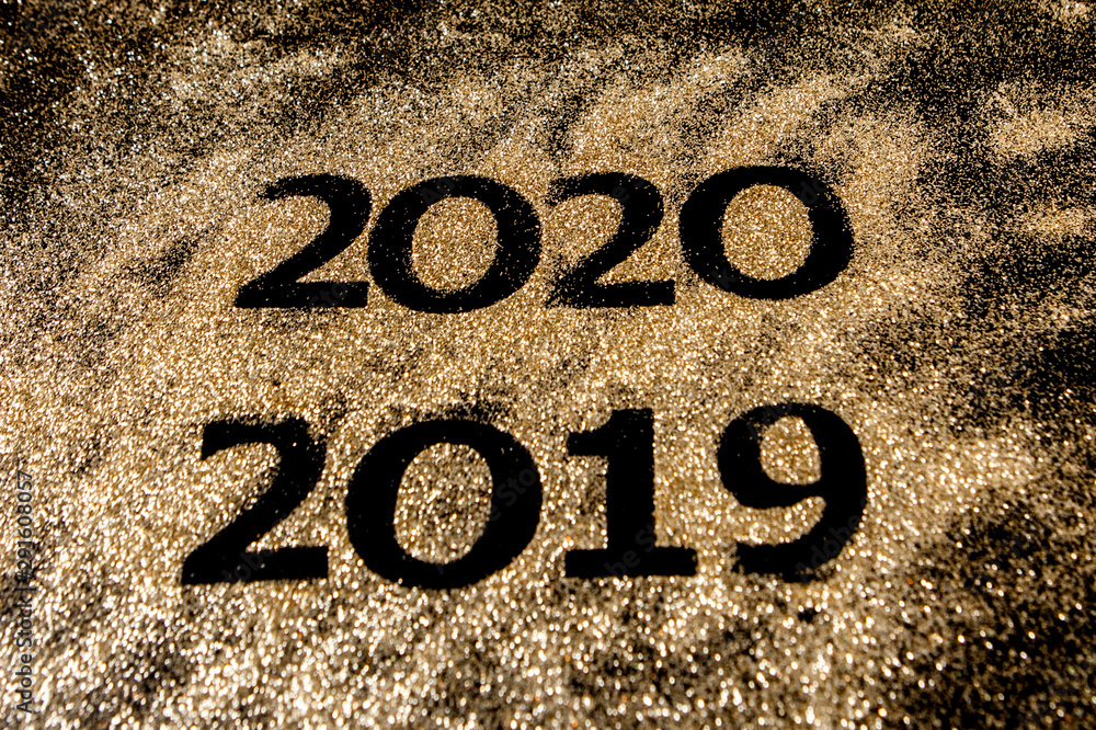 Beautiful sparkling Golden Numbers of 2019 to 2020 on black background for design, happy new year concept Beautiful sparkling Golden Numbers of 2019 to 2020 on black background for design, happy new year concept