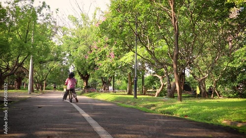 Wallpaper Mural children on a bicycle bike balance  at asphalt road in park. Torontodigital.ca