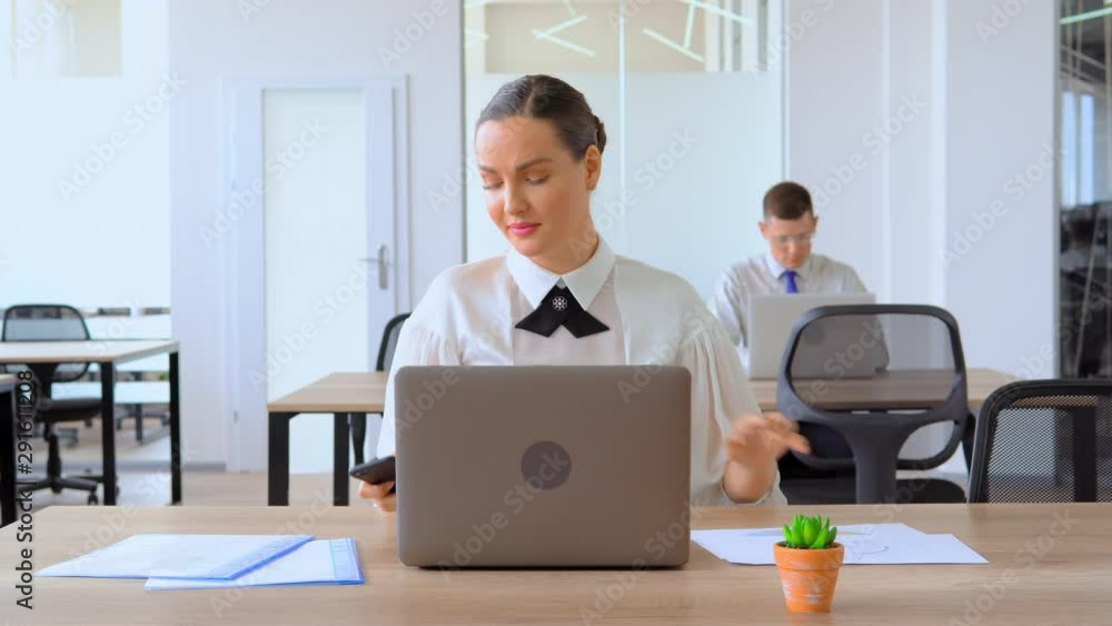 busy business woman entering data on computer active manager sitting at the desk in modern office manager in white shirt at work busy business woman entering data on computer active manager sitting at the desk in modern office manager in white shirt at work