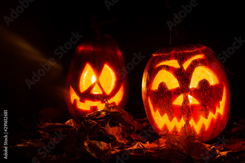 luminous pumpkins in the dark for the autumn Halloween holiday. Jack's grinning head. Magical bright neon green and red light in the darkness of Freezelight. All Saints' Day...
