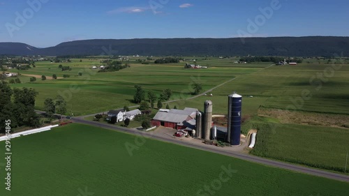 Aerial Kishacoquillas farm Big Valley Pennsylvania corn fields. Settled 1700's pioneer religious settlement. Old Amish Mennonite town. Rural old order. farming horse equipment. photo