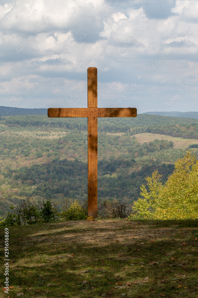 Large wooden cross in the mountain, cross overlooking valley Large wooden cross in the mountain, cross overlooking valley