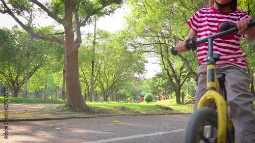Wallpaper Mural children on a bicycle bike balance  at asphalt road in park. Torontodigital.ca