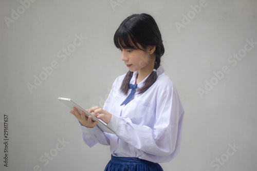 thai high school student uniform beautiful girl using her tablet