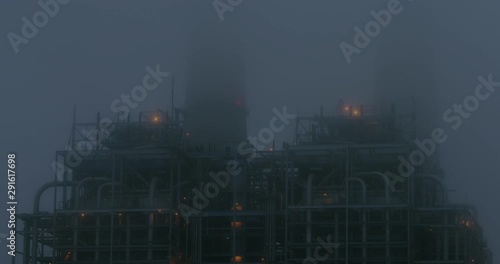 Fog Rolls Across Power Plant Pipes At Night