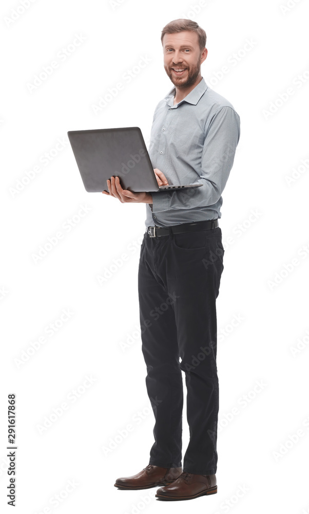 in full growth. smiling young businessman with laptop. in full growth. smiling young businessman with laptop.