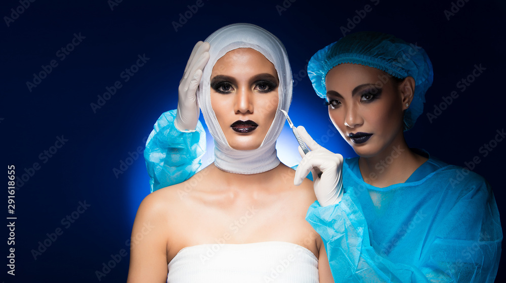 Beautician Doctor check diagnose status of treatment after plastic surgery  on Asian Woman with Cosmetic glitter bandage wrap head feel pain hurt, blue  tone color from studio lighting copy space Photos