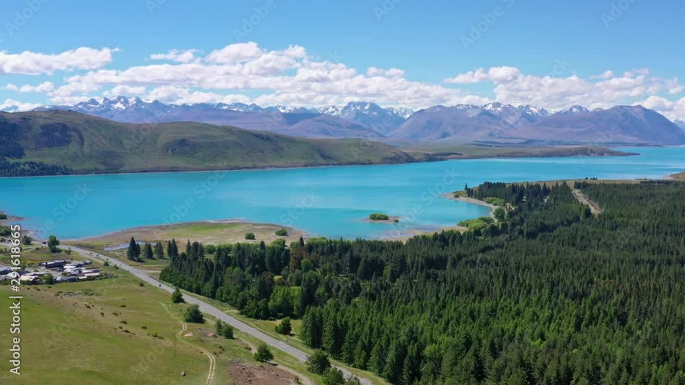 View of lake Tekapo, bushy green forest and Tekapo town, New Zealand View of lake Tekapo, bushy green forest and Tekapo town, New Zealand