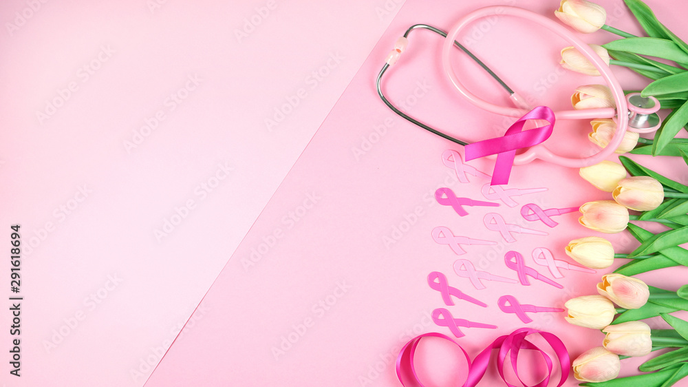 Pink Ribbon Breast Cancer Awareness Month concept flat lay on pink background with copy space.