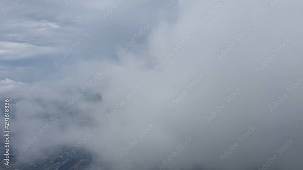 City view from airplane to fly through the cloud before landing and got air pocket City view from airplane to fly through the cloud before landing and got air pocket