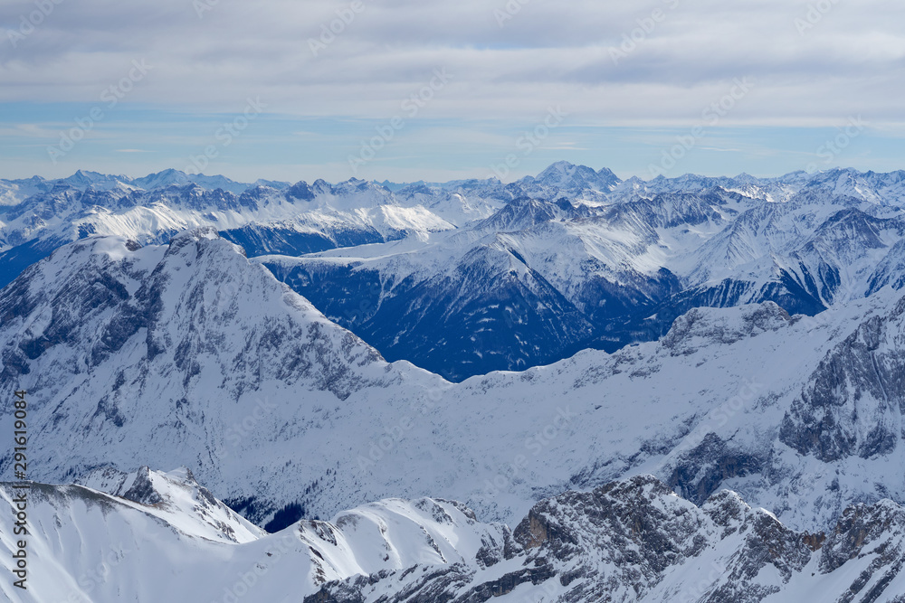 Alpine mountains, panoramic view from the top of the Zugspitze peak, Germany. It lies south of the town of Garmisch-Partenkirchen.                               