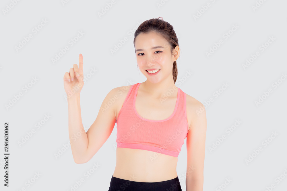 Beautiful portrait young asian woman in sport workout confident pointing and presenting and show something isolated on white background, asia girl exercise for fit with health and wellness concept.