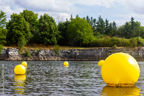 yellow floating balls buoy on a river in Gatineau Lac Leamy lake photo