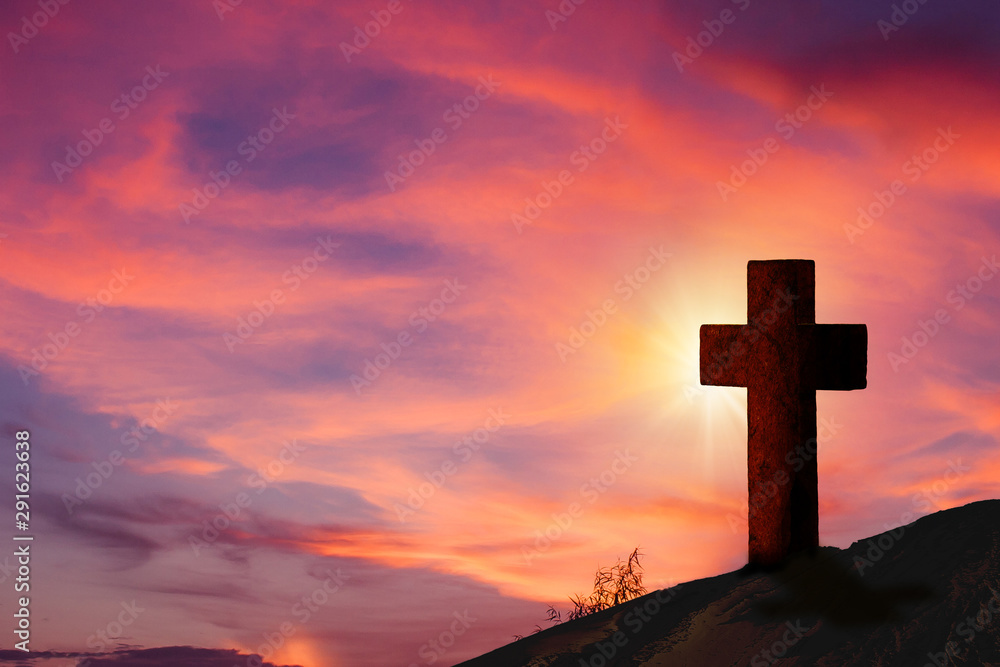 Silhouette wooden cross on hill with beautiful landscape in background.
