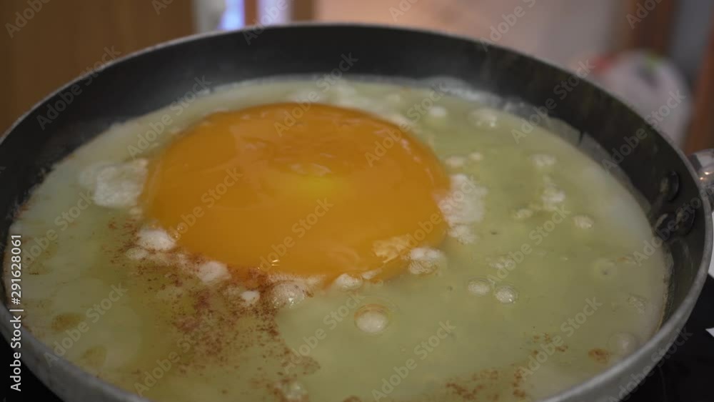 Zooming out view of large ostrich egg being cooked in a pan, filmed in 4k Zooming out view of large ostrich egg being cooked in a pan, filmed in 4k