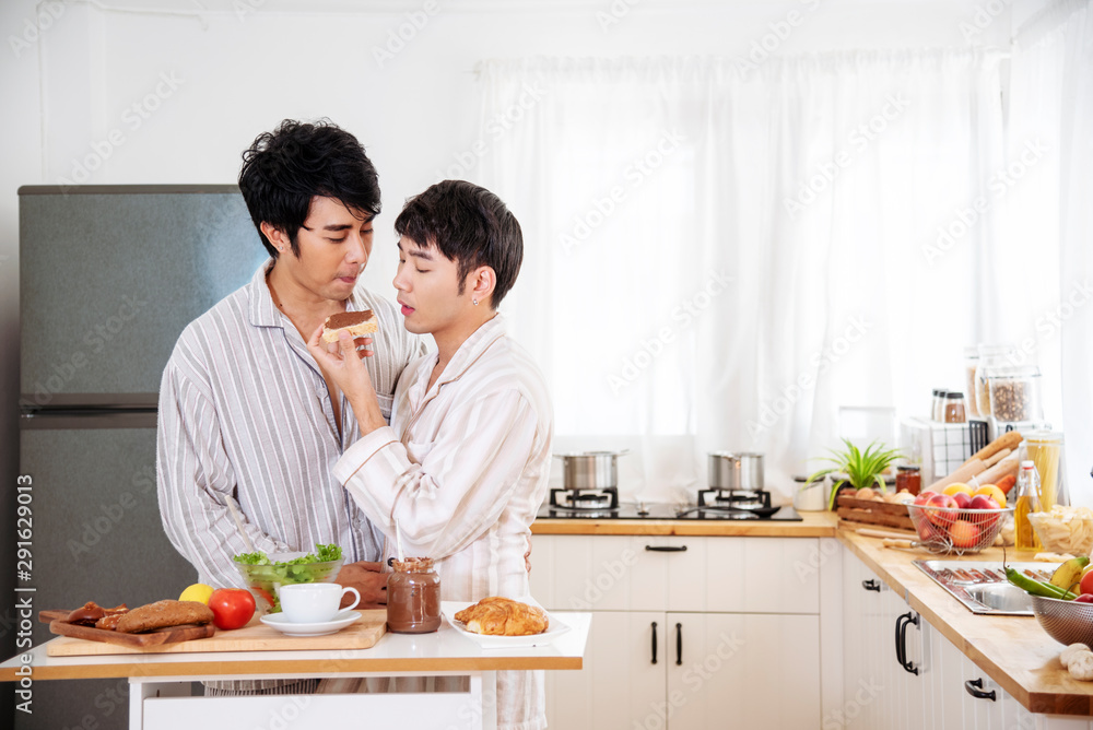 Asian gay couple homosexual cooking together in the kitchen prepare fresh vegetable make organic salad healthy food. Asian people happy time smile, laugh in kitchen. LGBTQ relation lifestyle concept Asian gay couple homosexual cooking together in the kitchen prepare fresh vegetable make organic salad healthy food. Asian people happy time smile, laugh in kitchen. LGBTQ relation lifestyle concept