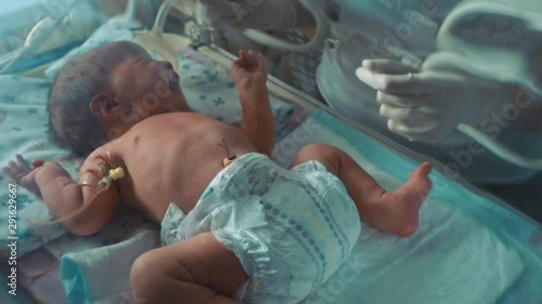 Newborn baby in an incubator