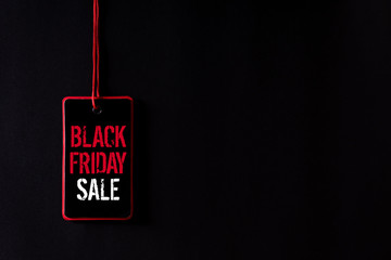 Black Friday Sale text on a red and black tag. Shopping concept.