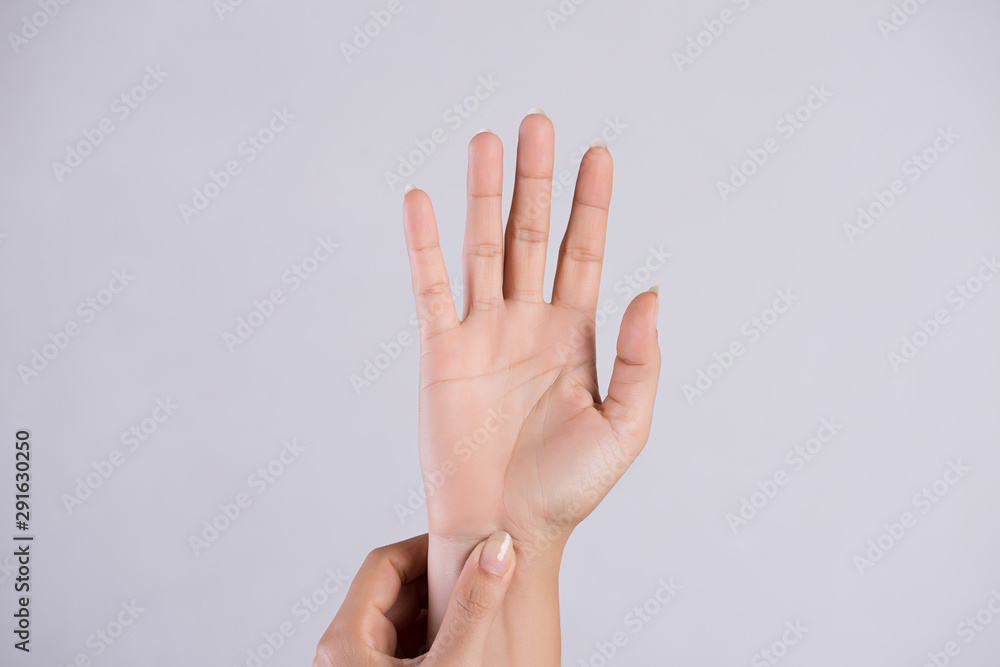 Healthcare and medical concept. Woman massaging her painful wrist. Healthcare and medical concept. Woman massaging her painful wrist.