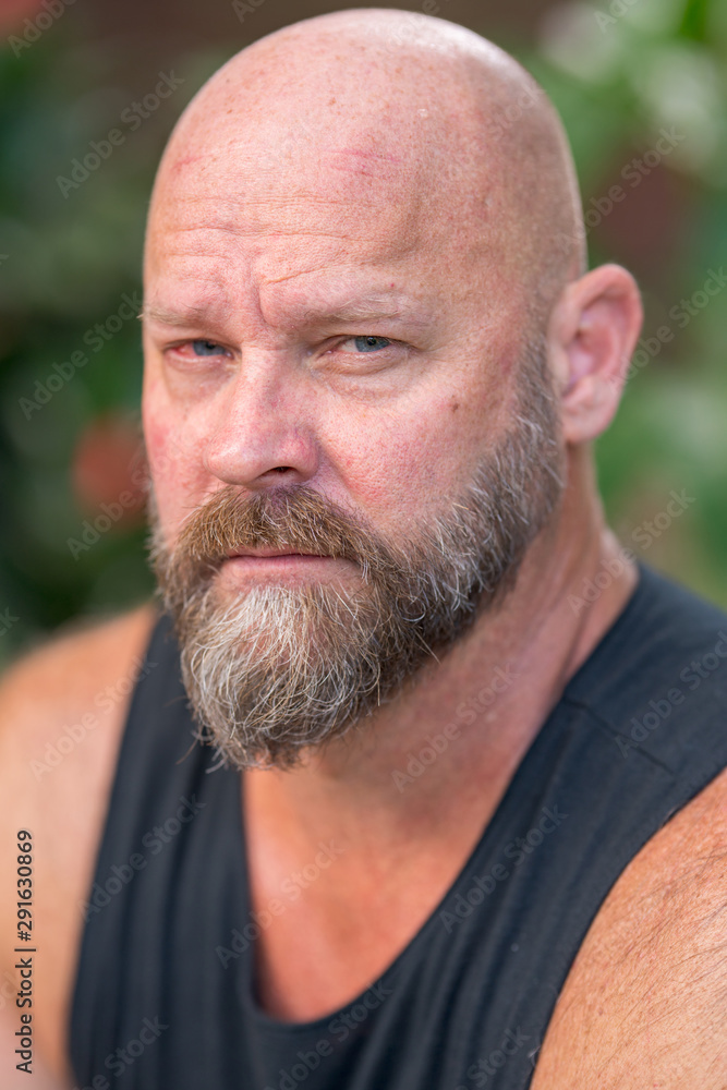 Portrait headshot handsome man staring directly into camera Portrait headshot handsome man staring directly into camera